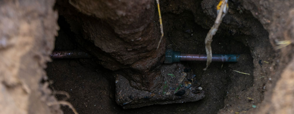 A water service line visible after excavating.