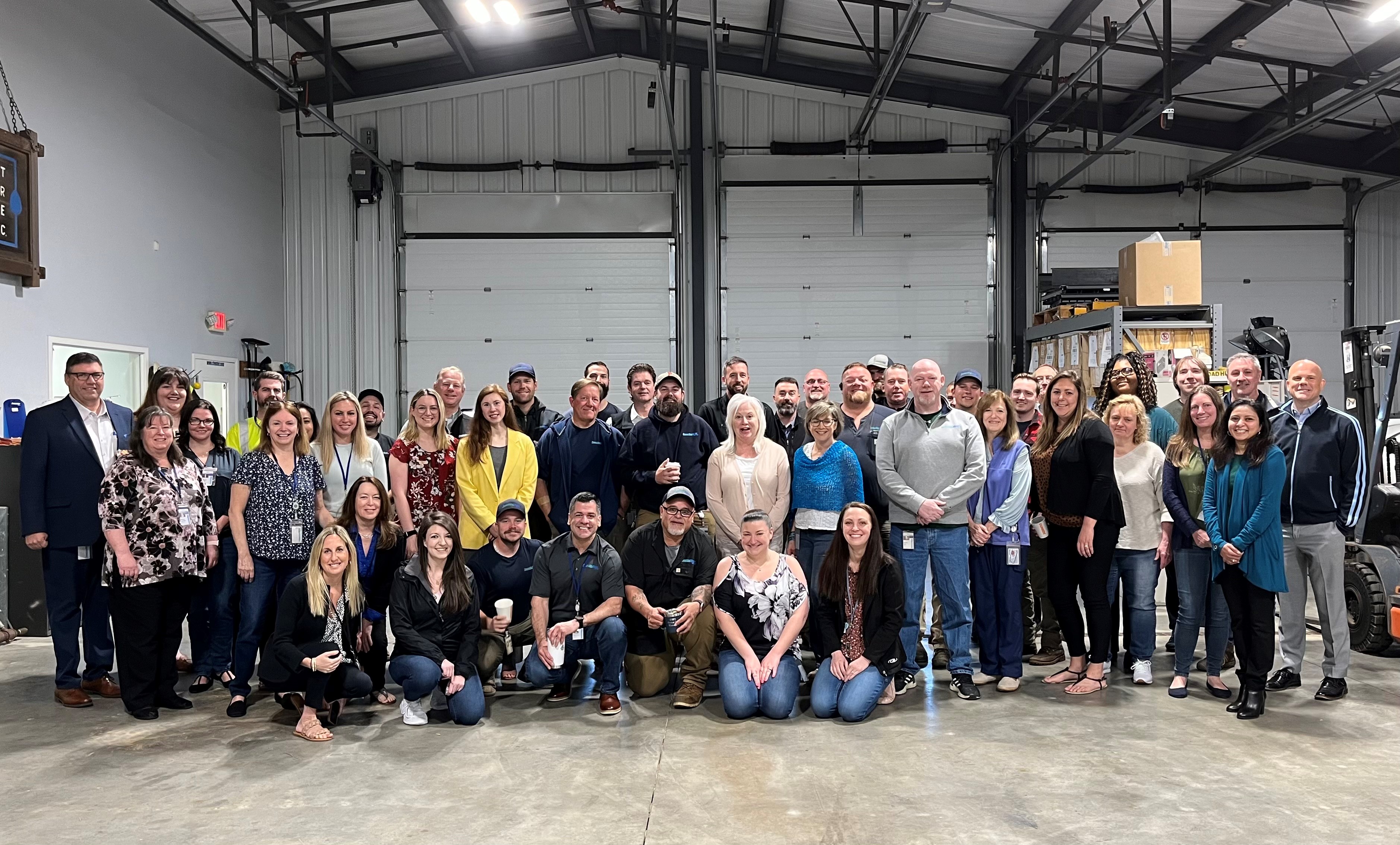 group shot of CT Water employees inside a warehouse