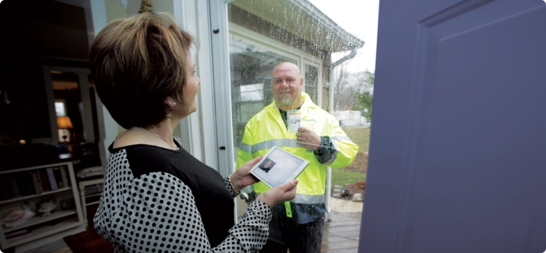 CT Water employee showing their badge to a customer at the front door