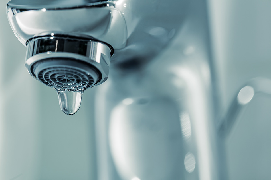 water droplet dripping from a a faucet